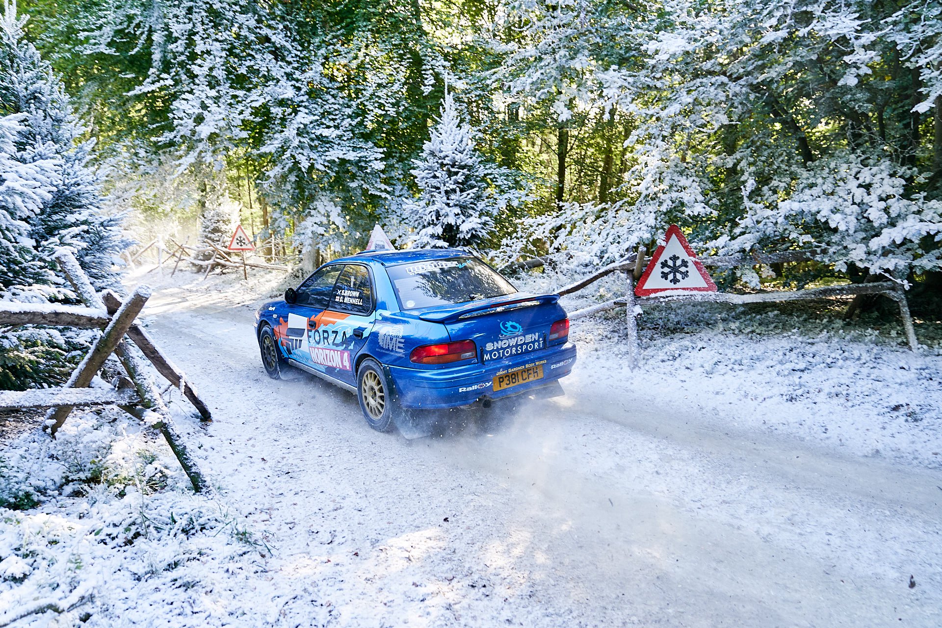 Rally track , car driving along winter with fake snow surround