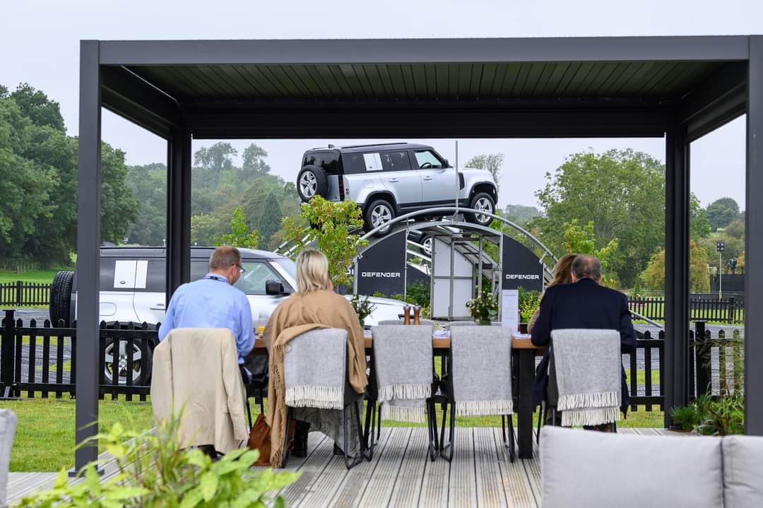 temporary event structure with cube covering and chairs on viewing deck