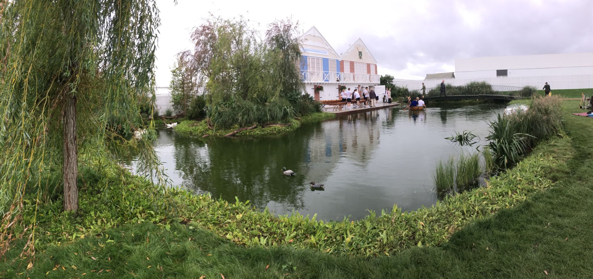 built lake at Goodwood with planting, large trees, bridge and building. All built bespoke for an event.