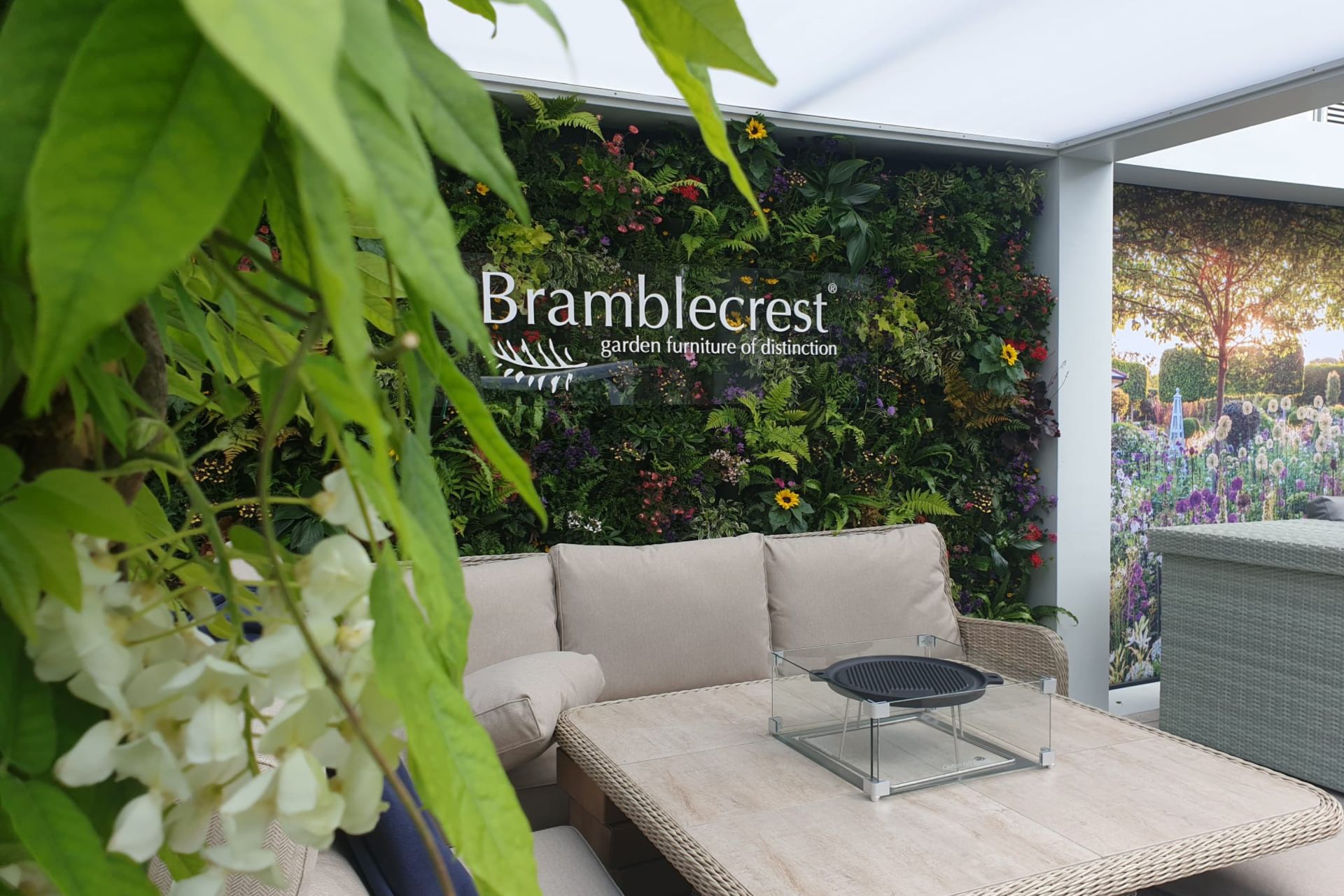 bramblecrest living wall feature to back of cube structure at exhibition with furniture infront