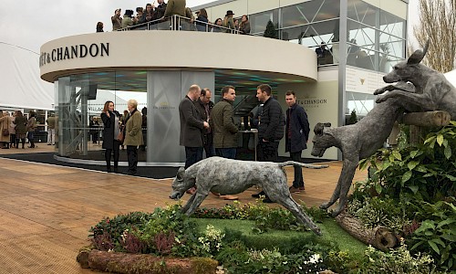 Cheltenham Festival jumping dogs statue infront of moet and chandon bar