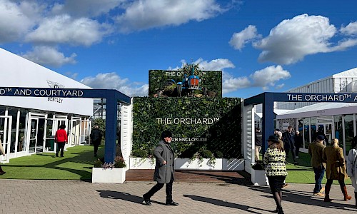 Cheltenham Festival the orchard entrance with artificial wall panels and tractor on roof
