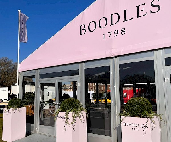 entrance branding to tall planted towers with client logo to front and painted brands pink