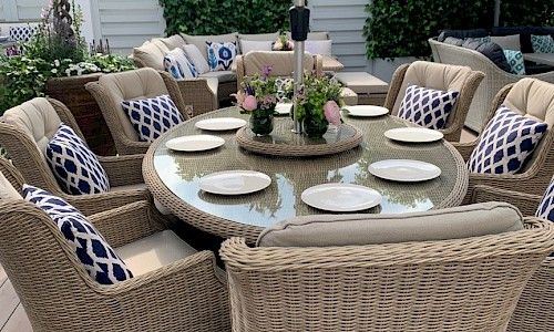 RHS Chelsea Flower Show rattan dining table set with floral table centers
