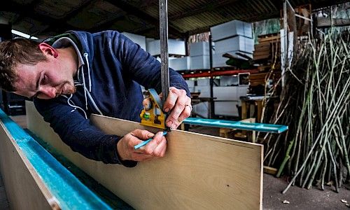 January Furniture Show carpenters building in warehouse